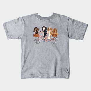 Four Cavalier King Charles Spaniels Riding a Bike Kids T-Shirt